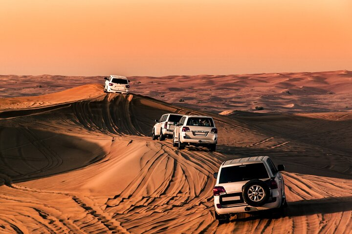Experience the allure of Dubai's desert where 4X4 adventures unfold against stunning sand dunes offering exhilarating rides and a glimpse into traditional culture and hospitality.